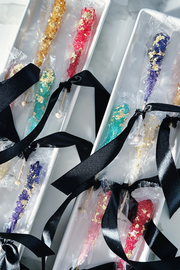 Learn how to transform rock candy into gem-inspired jewelry for a "She's a Gem" party. And tie with a bow to match your party decor.