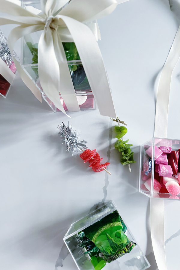 DIY candy packaging idea featuring gummy belts threaded on cocktail picks, included in snack box ideas for birthdays, weddings, or holiday gifts.