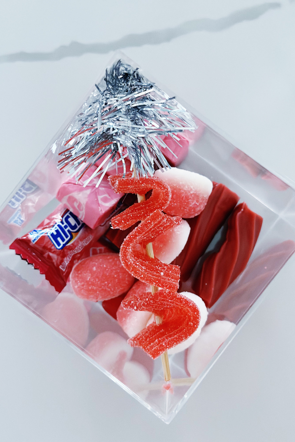 Candy boutique DIY gift idea featuring an acrylic box filled with all pink candies to inspire your own party favor or gift creations.