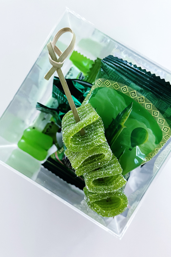 Creative candy packaging idea with green-themed candy boxes designed for inspiration at birthday parties, weddings, or themed events.